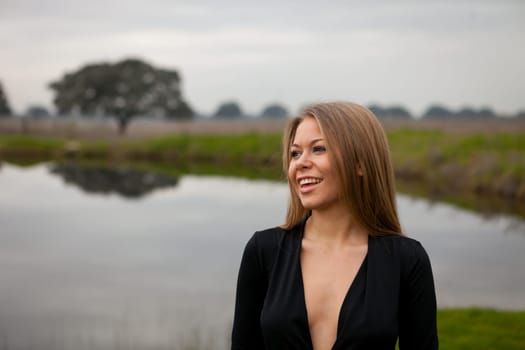 Attractive girl with sexy black shirt in the field