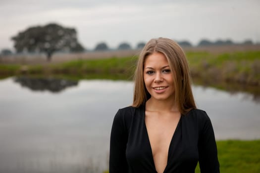 Attractive girl with sexy black shirt in the field