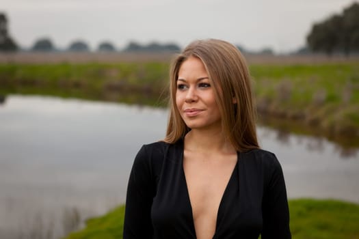 Attractive girl with sexy black shirt in the field