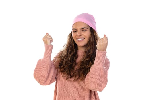 Hopeful woman with cancer wearing a thoughtful pink scarf isolated on a white background
