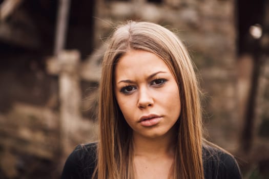 Beautiful blonde girl wih long hair and a sad expression