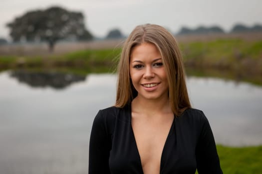 Attractive girl with sexy black shirt in the field