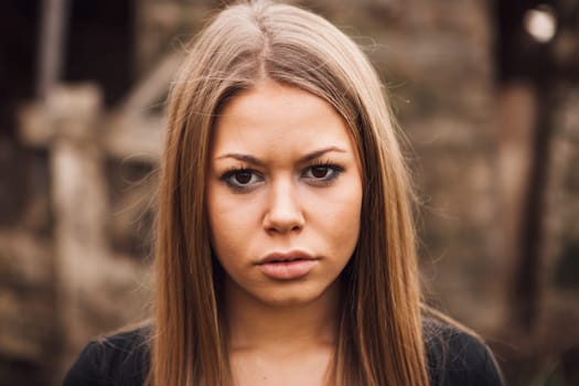 Beautiful blonde girl wih long hair and a sad expression