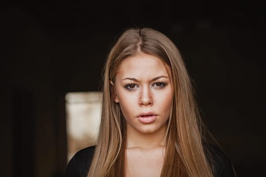 Beautiful blonde girl wih long hair and a sad expression