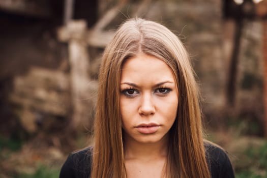 Beautiful blonde girl wih long hair and a sad expression