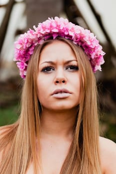 Beauty portrait of attractive blond girl with a beautiful pink headband