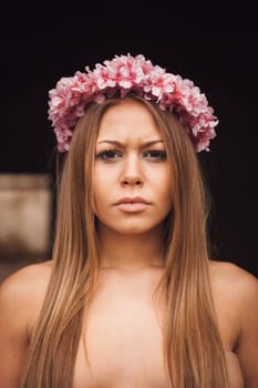 Beauty portrait of attractive blond girl with a beautiful pink headband