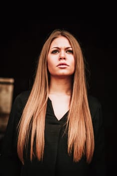 Beautiful blonde girl with black shirt looking up
