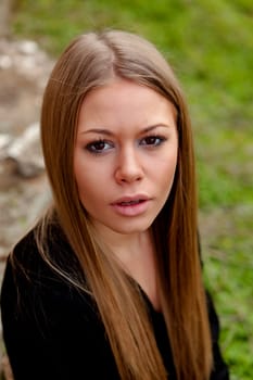 Beautiful blonde girl with long hair looking at camera