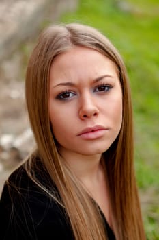Beautiful blonde girl with long hair looking at camera