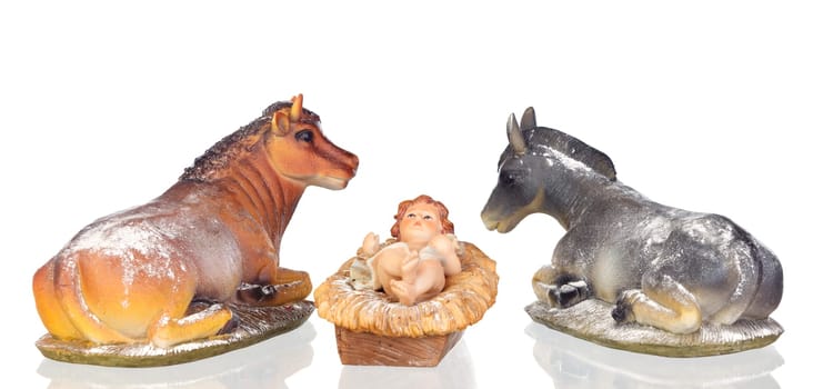 The Baby Jesus in the manger with the ox and the mule, isolated on white background