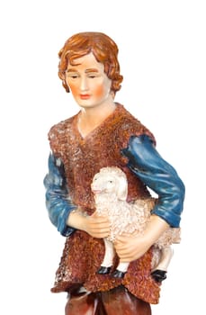 Figure of the shepherd with a sheep for the nativity portal isolated on a white background