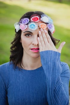 Pretty brunette girl with flower crown in the park