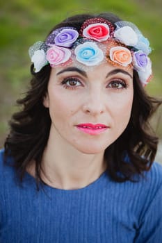 Pretty brunette girl with flower crown in the park