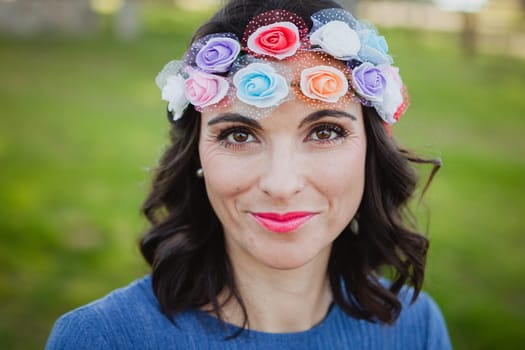 Pretty brunette girl with flower crown in the park
