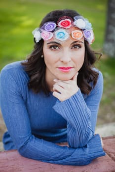 Pretty brunette girl with flower crown in the park