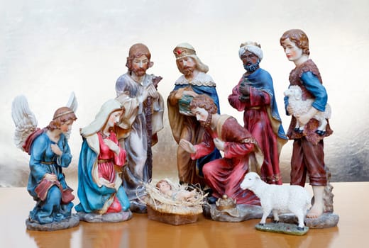 Nativity Scene on a wooden surface and a golden background