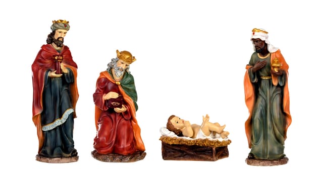 The three wise men and baby Jesus. Ceramic figures isolated on white background