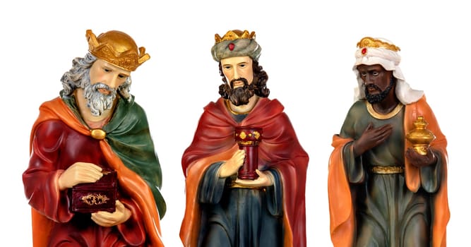 The three wise men and baby Jesus. Ceramic figures isolated on white background