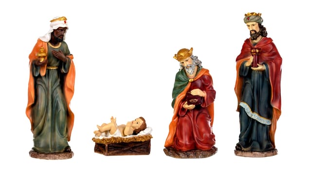 The three wise men and baby Jesus. Ceramic figures isolated on white background
