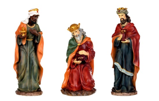 The three wise men and baby Jesus. Ceramic figures isolated on white background