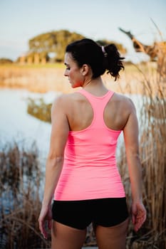 Female athlete with sportswear in nature to train