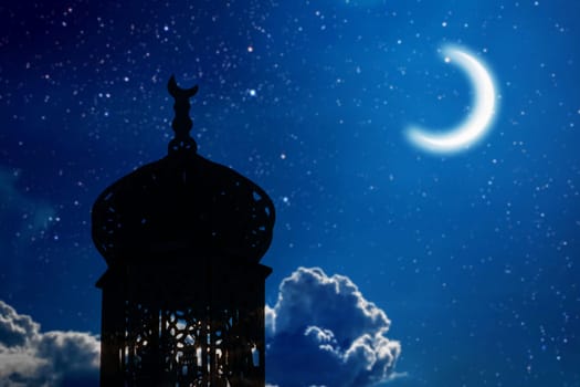 Ramadan Kareem background. Mosque silhouette in night sky with crescent moon and star