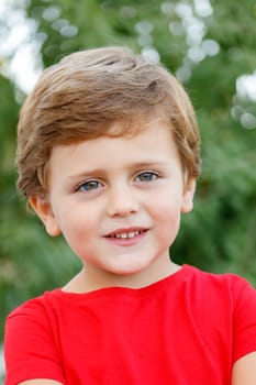 Happy child with red t-shirt playing in the garden