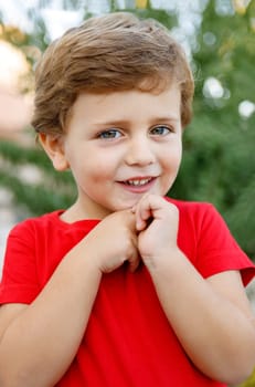 Happy child with red t-shirt playing in the garden