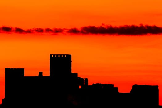 Silhouette of a amazing castle over a red sky
