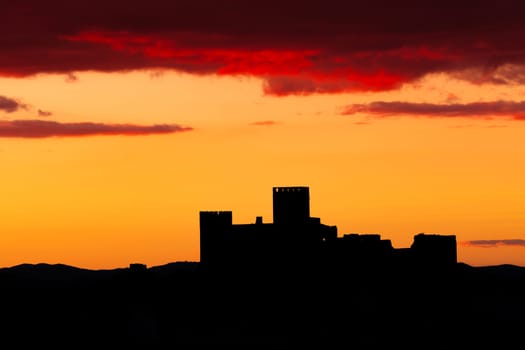 Silhouette of a amazing castle over a red sky