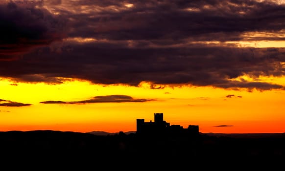 Silhouette of a amazing castle over a red sky