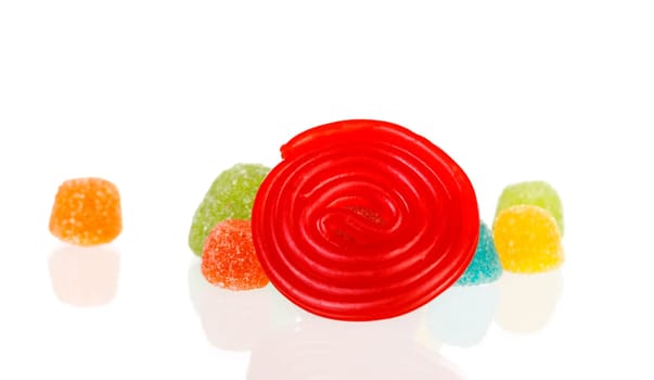 Red spiral of licorice and jelly beans isolated on a white background