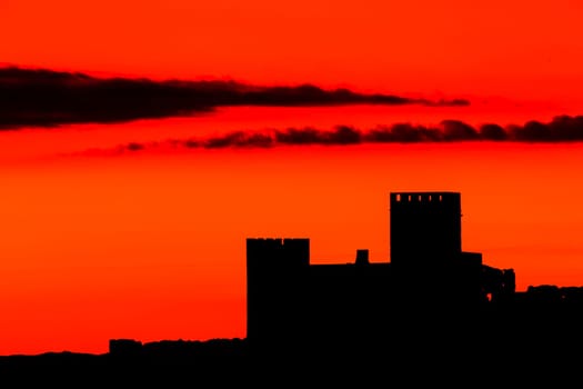 Silhouette of a amazing castle over a red sky