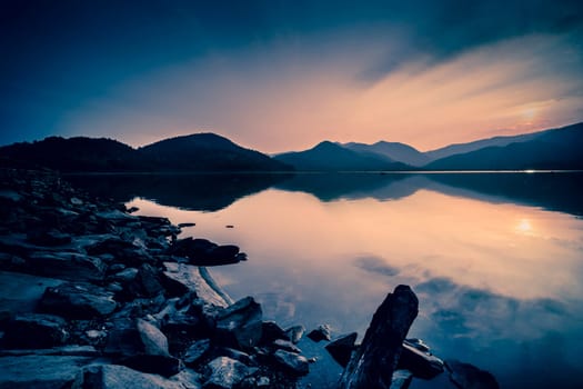 Beautiful Lake over the Mountains background Long Exposure. Travel place on good vacation time.