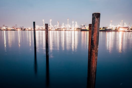 Cityscape industrial area at night and reflection in the river. Town Lake mirrored reflection