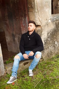 Attractive guy in a old house with black jersey