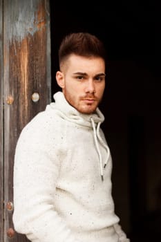Attractive guy in a old house with white jersey