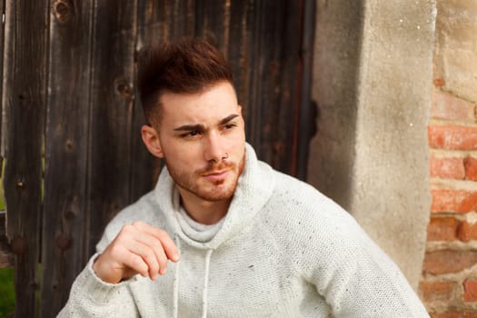 Attractive guy in a old house with white jersey