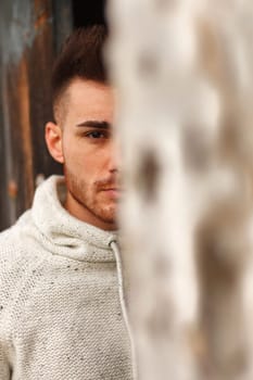 Attractive guy in a old house with white jersey