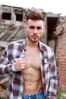 Attractive guy with the plaid shirt unbuttoned
