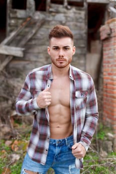 Attractive guy with the plaid shirt unbuttoned