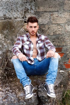 Attractive guy with the plaid shirt unbuttoned