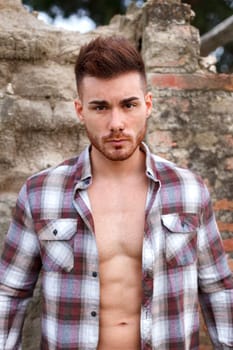 Attractive guy with the plaid shirt unbuttoned