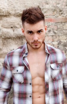 Attractive guy with the plaid shirt unbuttoned
