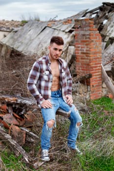 Attractive guy with the plaid shirt unbuttoned