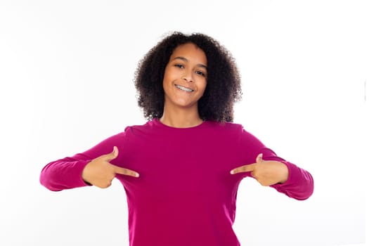 Beautiful teenager girl with pink sweater isolated on a white background