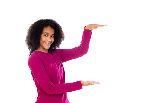 Teenager girl with afro hair wearing pink sweater isolated on a white background