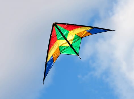 Colourful kite flying on a over blue sky