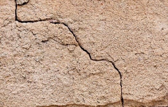 Crack in a wall on a cement surface